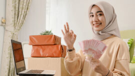 asian woman holds Indonesian rupiah